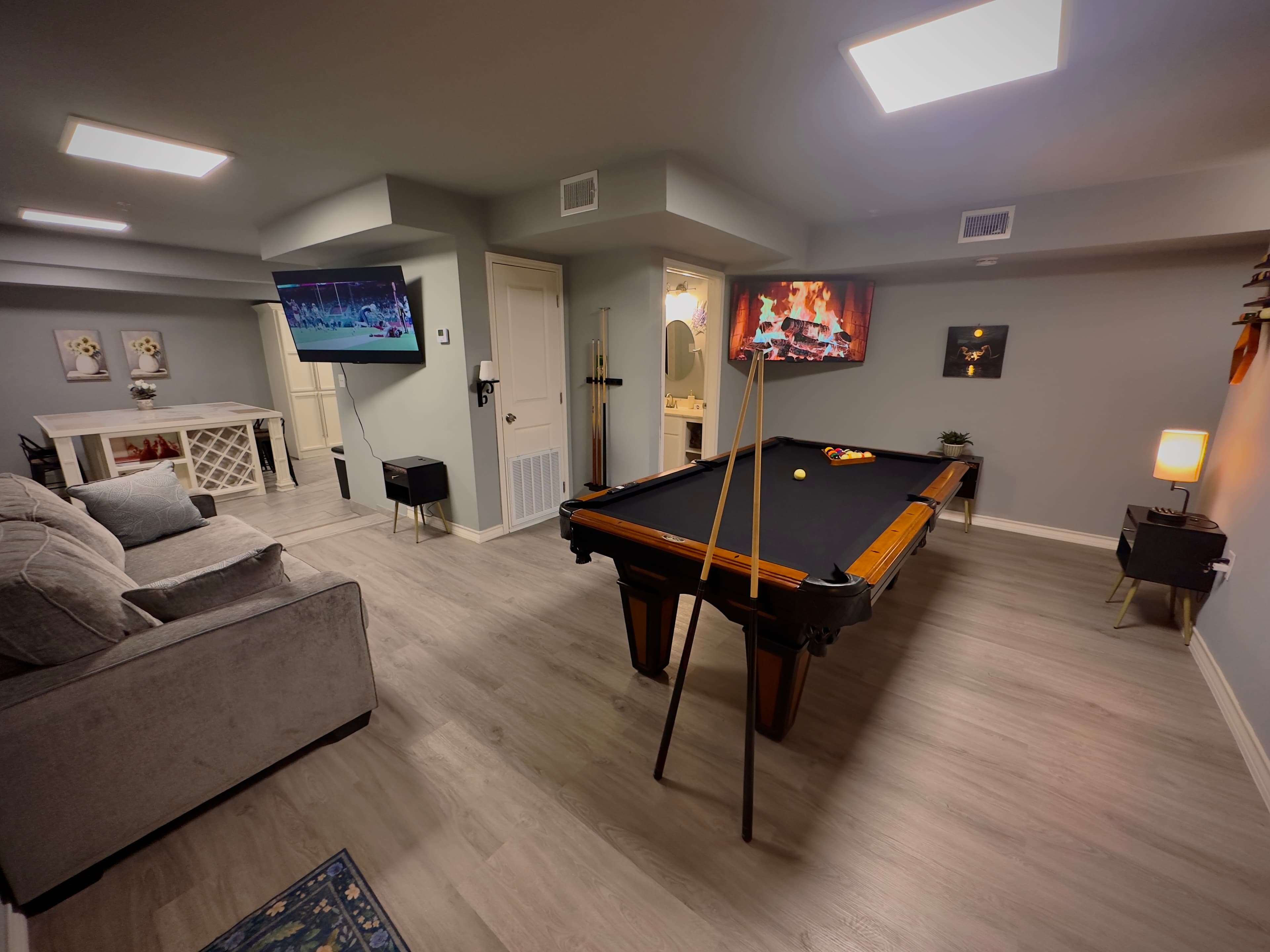 Apartment living area with a pool table and adjoining kitchen at RGV Coastal Stays